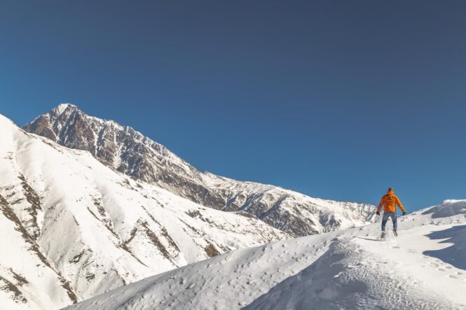 man on mountain with snow