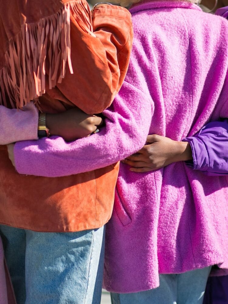 four person holding each others waist at daytime