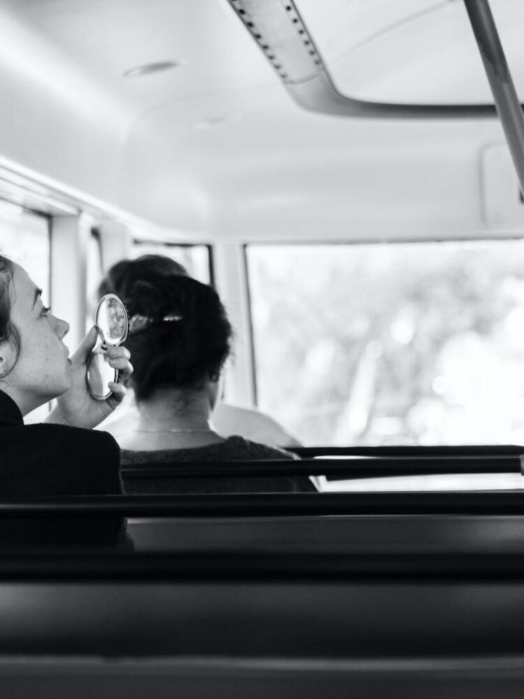 woman sitting on bus bench seat